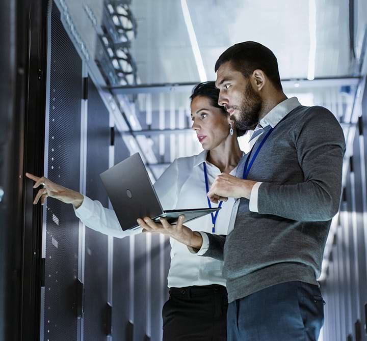 data infrastructure consultants in a server room checking systems