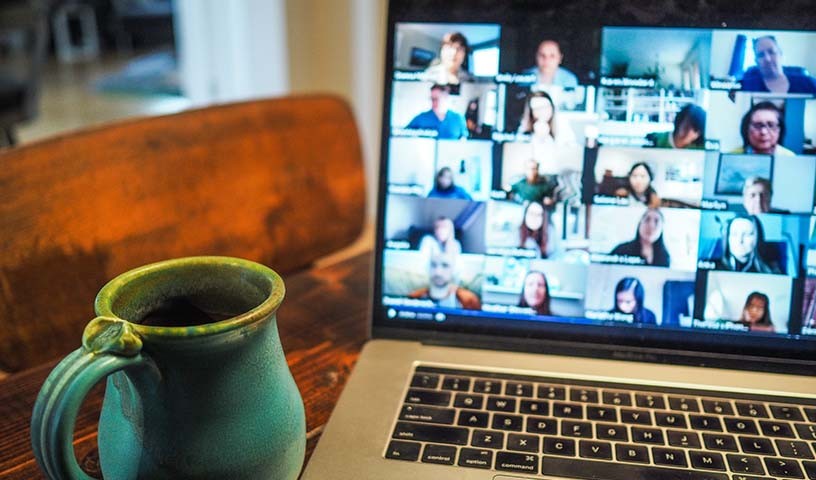 Open laptop with video conference squares on the screen