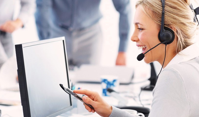 Professional talking with headset in front of a monitor