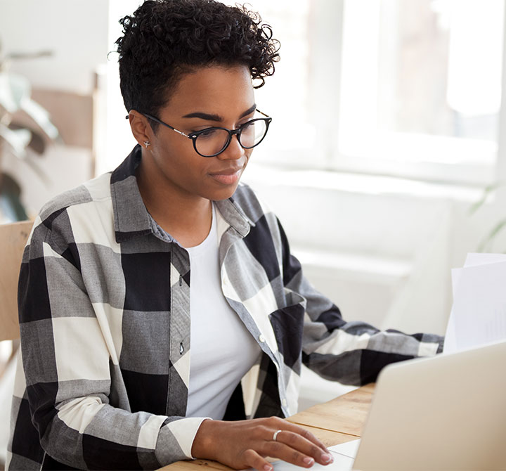 Woman working on laptop.