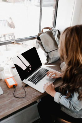 Business woman working on her laptop connecting to the wireless network device