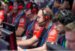 Online Gaming Support Team sitting with headsets in workplace and supporting gamers